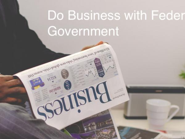 Man with newspaper and Do business with federal governments text