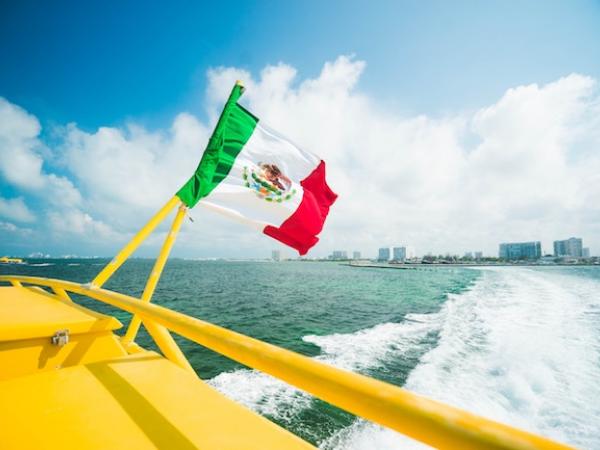 Boat in water with Mexican flag